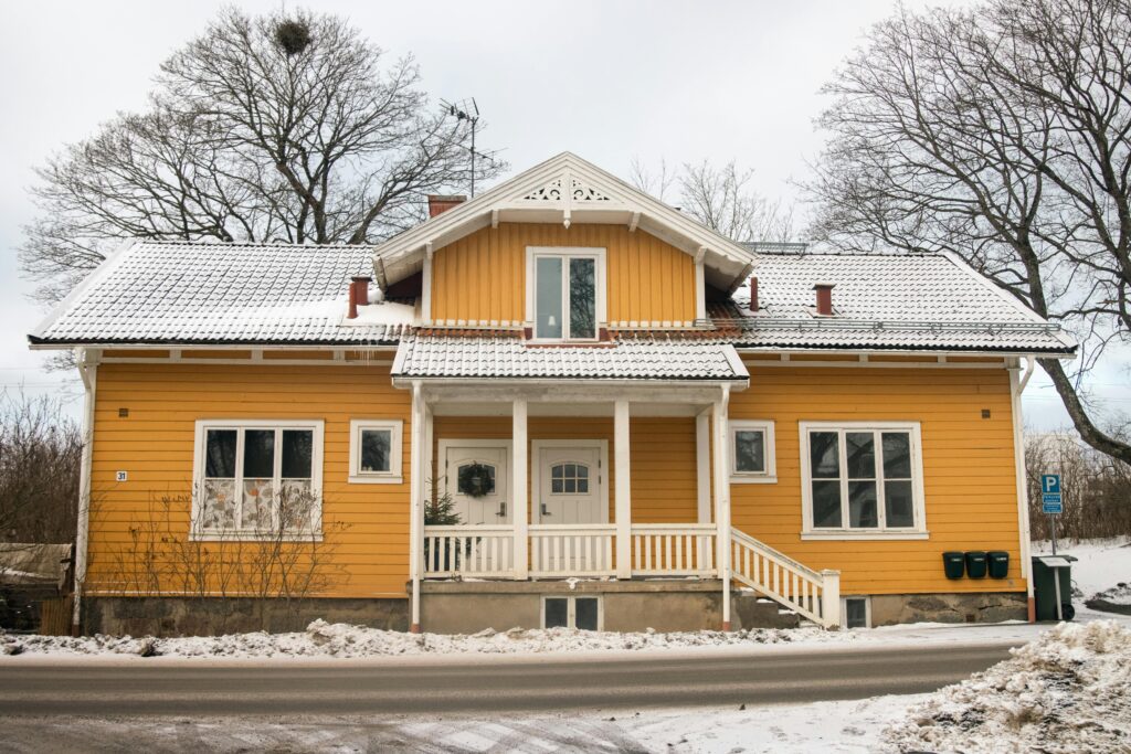 Bright yellow house in snowy Jönköping, Sweden during winter.
